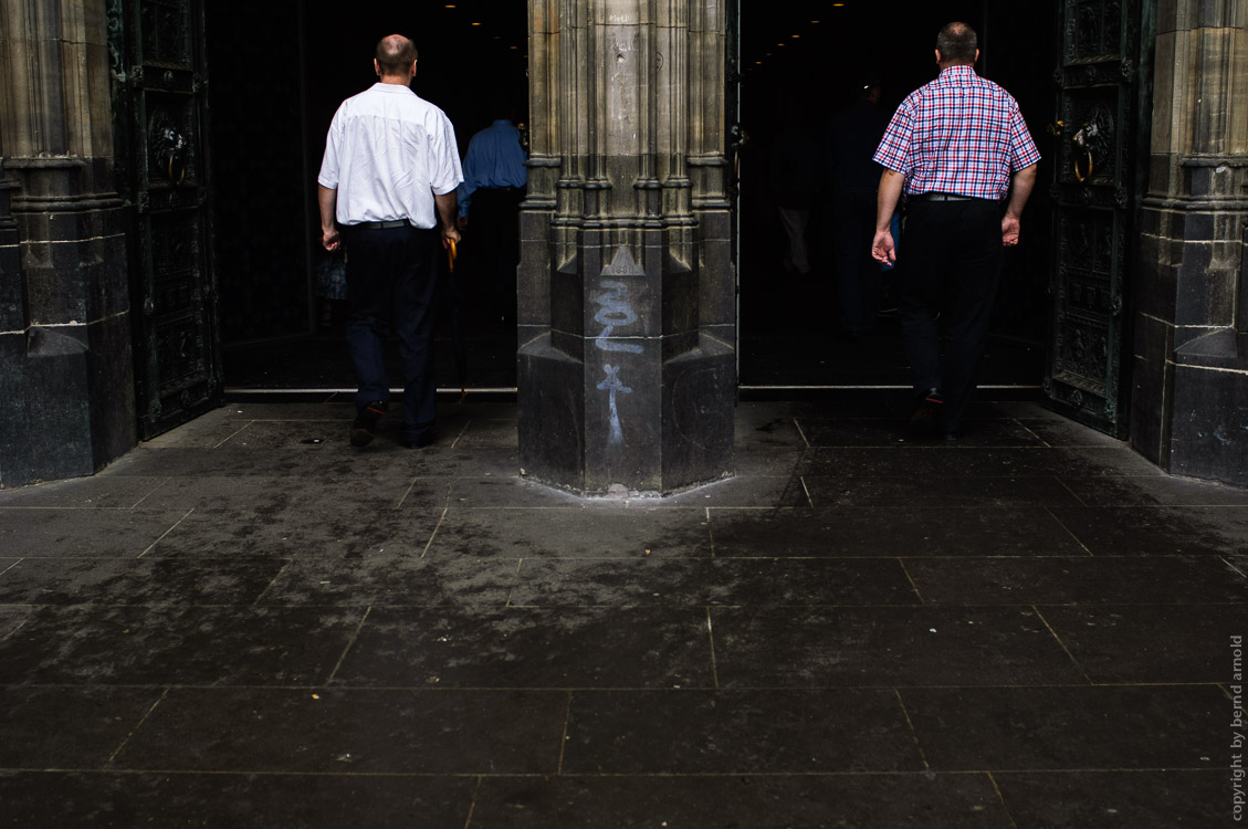 two men walked in to the Cologne cathedral at the West Portals – Photography and Portfolio